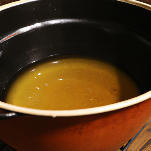 A Dutch oven being seasoned with vegetable oil before baking.